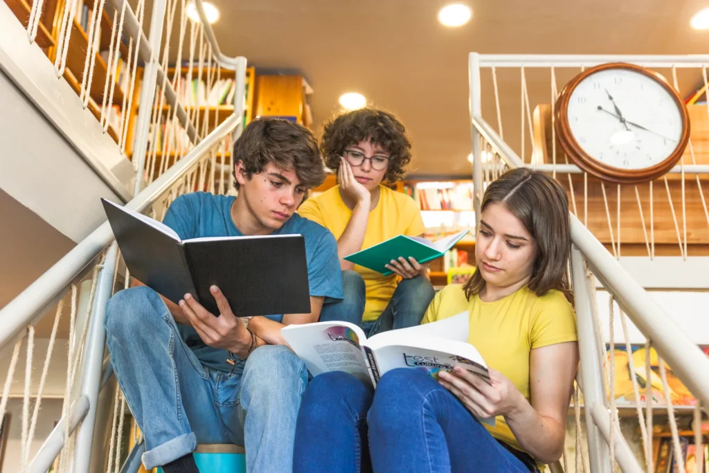 Teenagers sitting steps studying